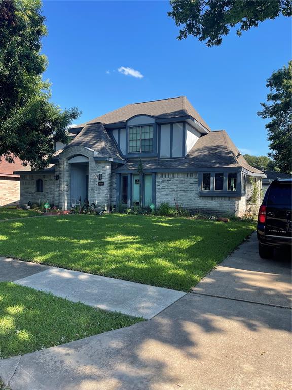 a front view of a house with a garden and yard