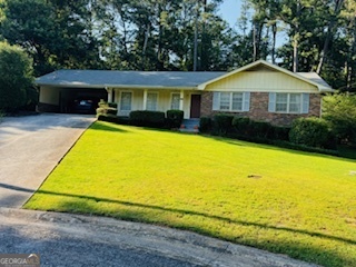 a front view of house with swimming pool and yard