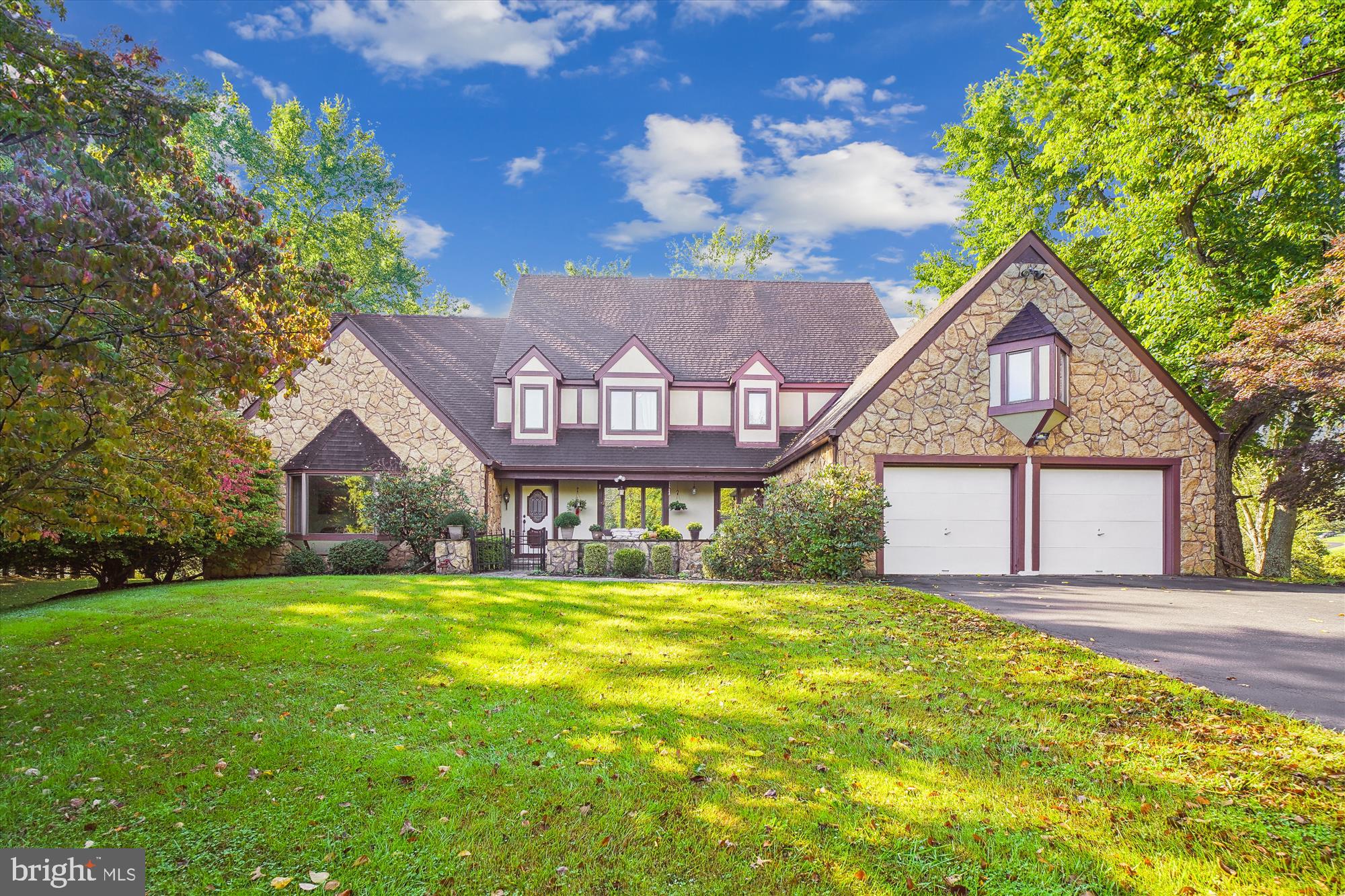 a view of a house with a big yard and large trees