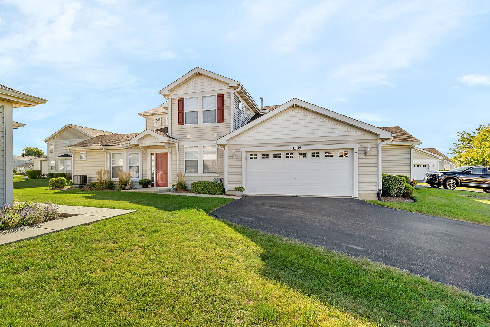 a front view of a house with a yard and garage