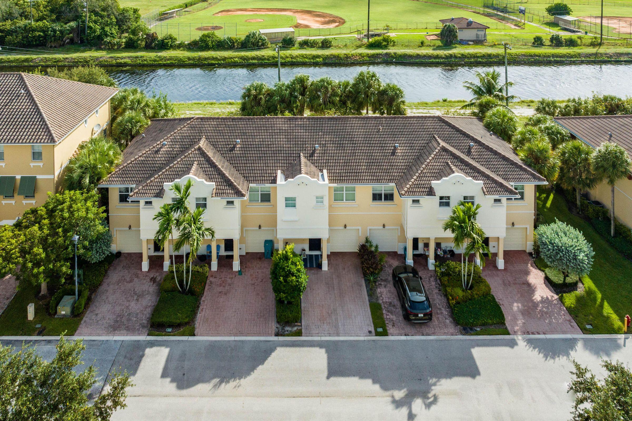 an aerial view of a house with garden space and lake view