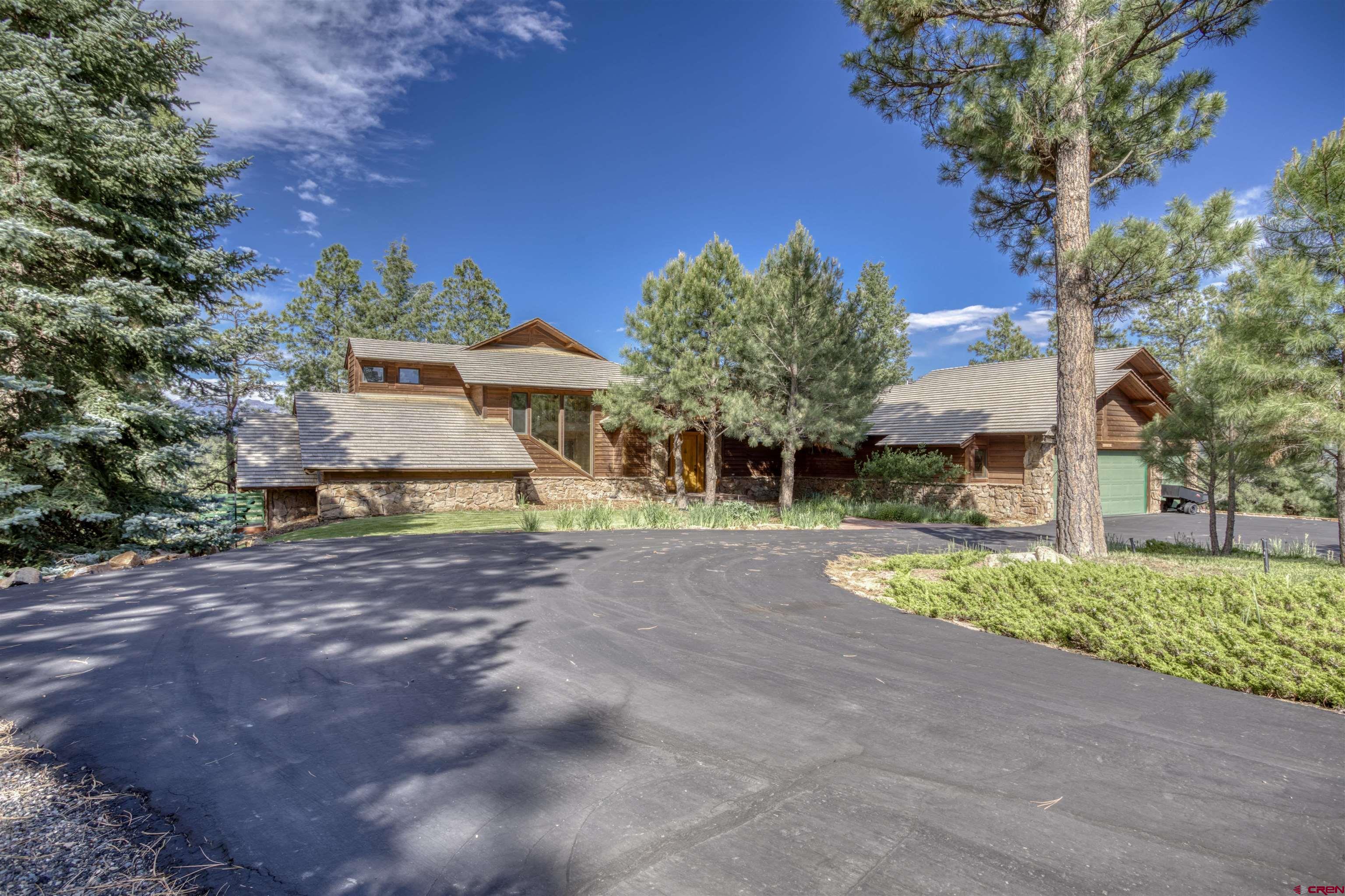 a front view of a house with a yard and outdoor seating