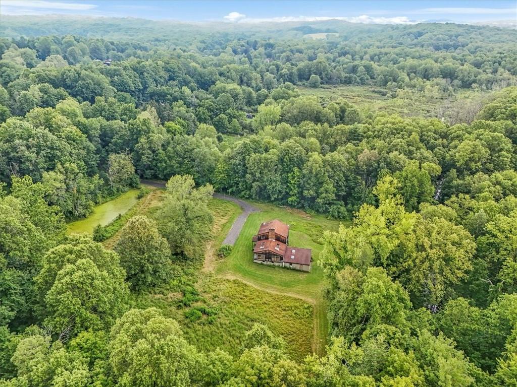 an aerial view of a houses with a yard