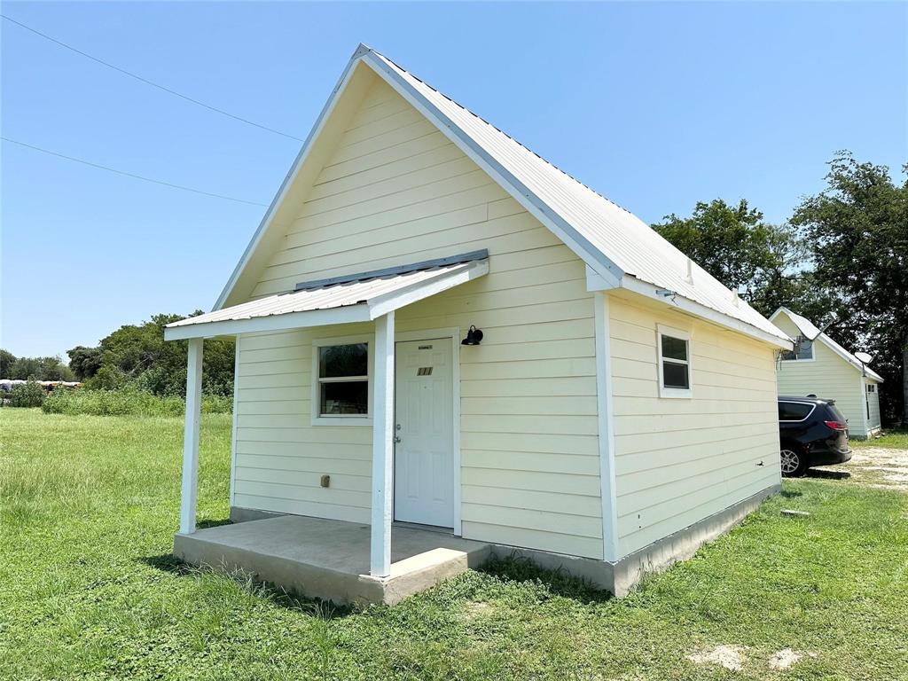 a view of a small house in the back yard