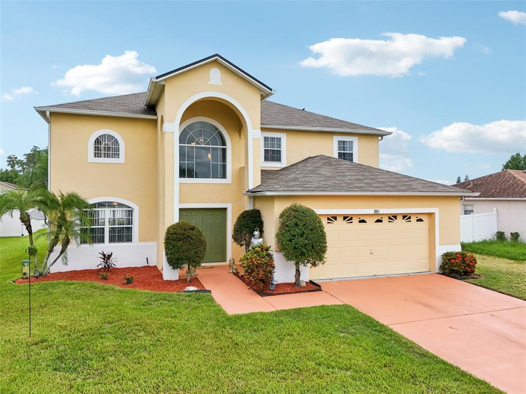 a front view of a house with a yard and garage