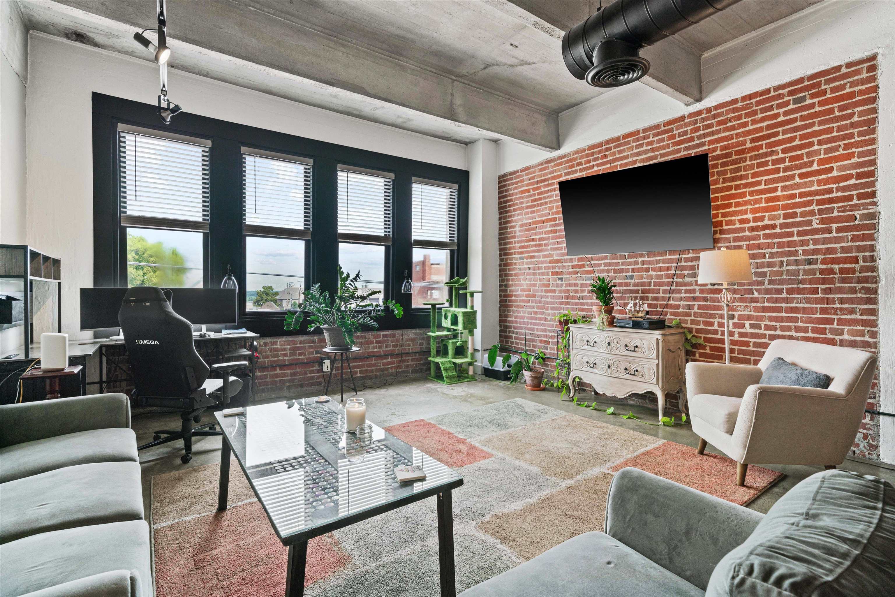 a living room with furniture and a flat screen tv