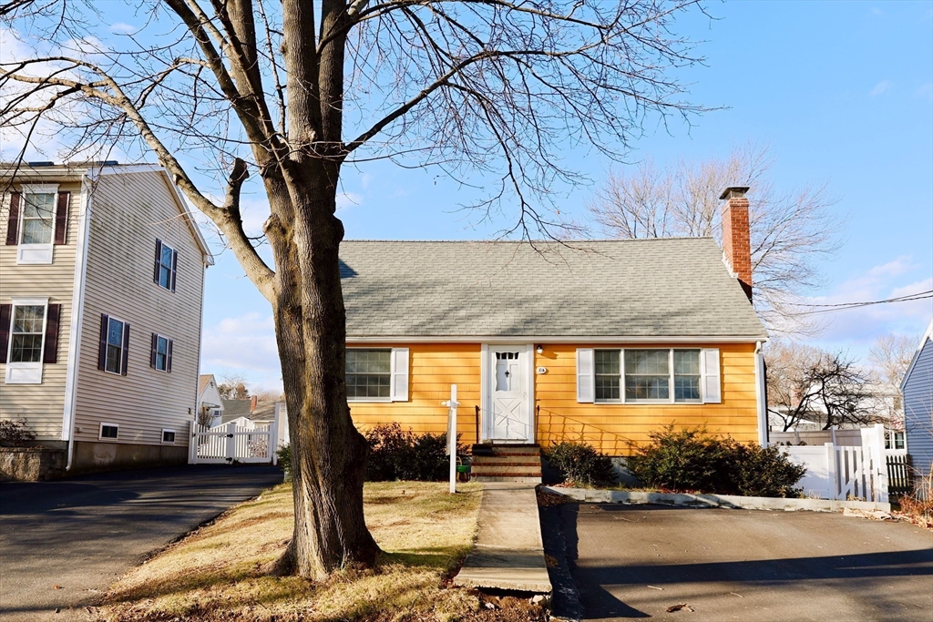 a front view of a house with outdoor seating