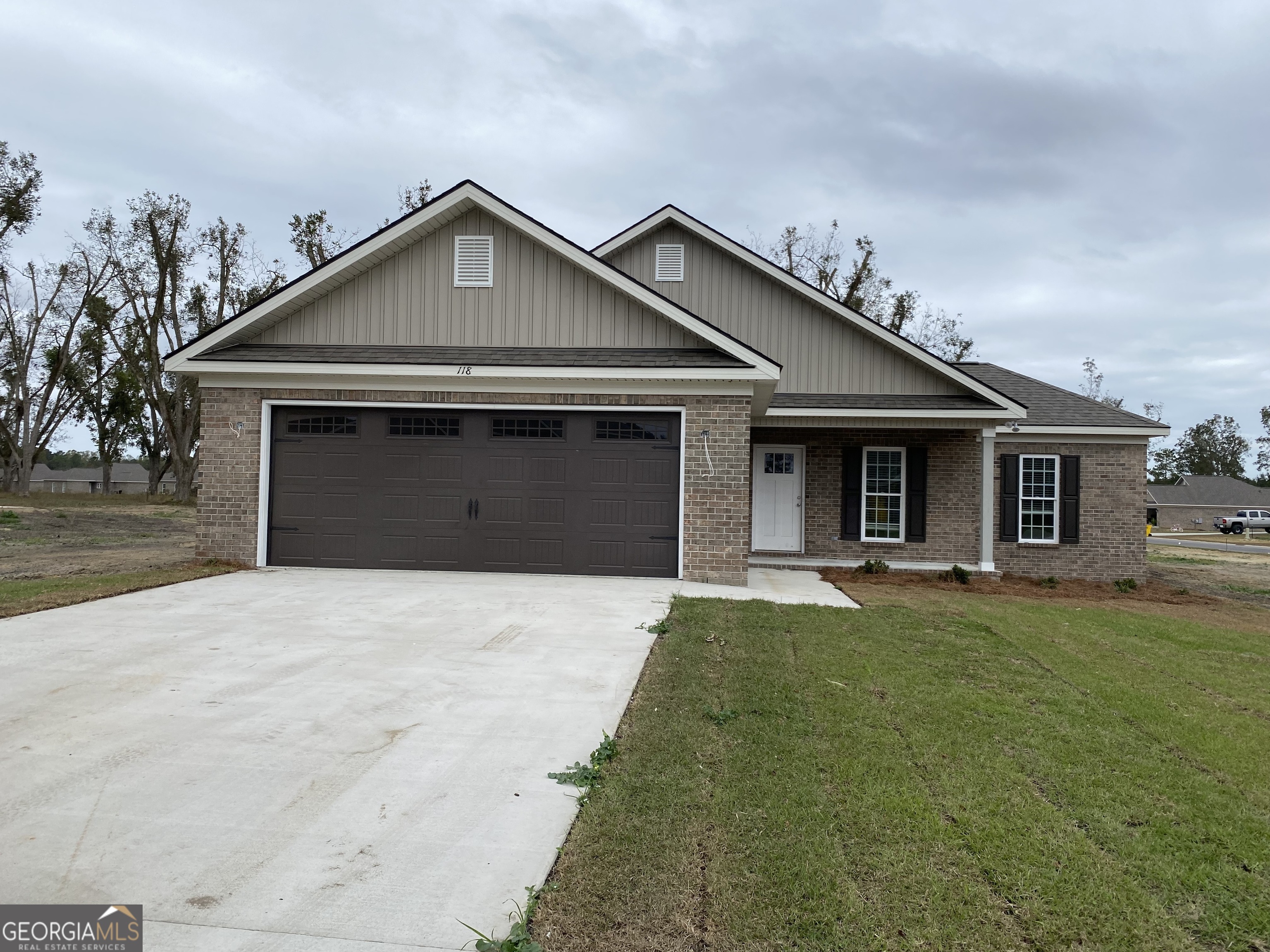 a front view of a house with a garden