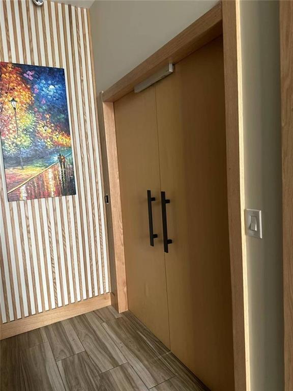 a view of a room with wooden floor and windows