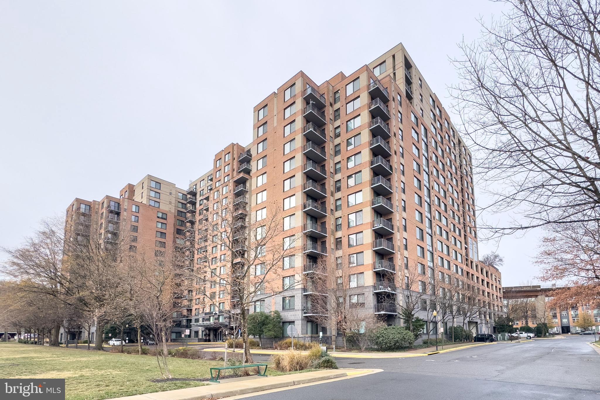 a view of a tall building next to a road