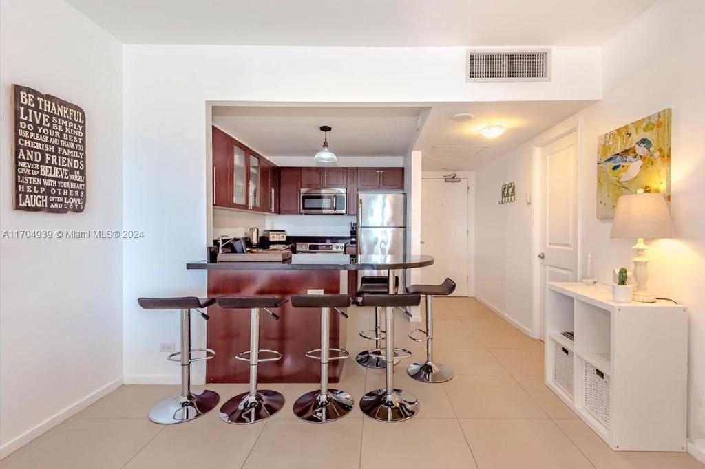 a view of a kitchen with kitchen island dining table and chairs