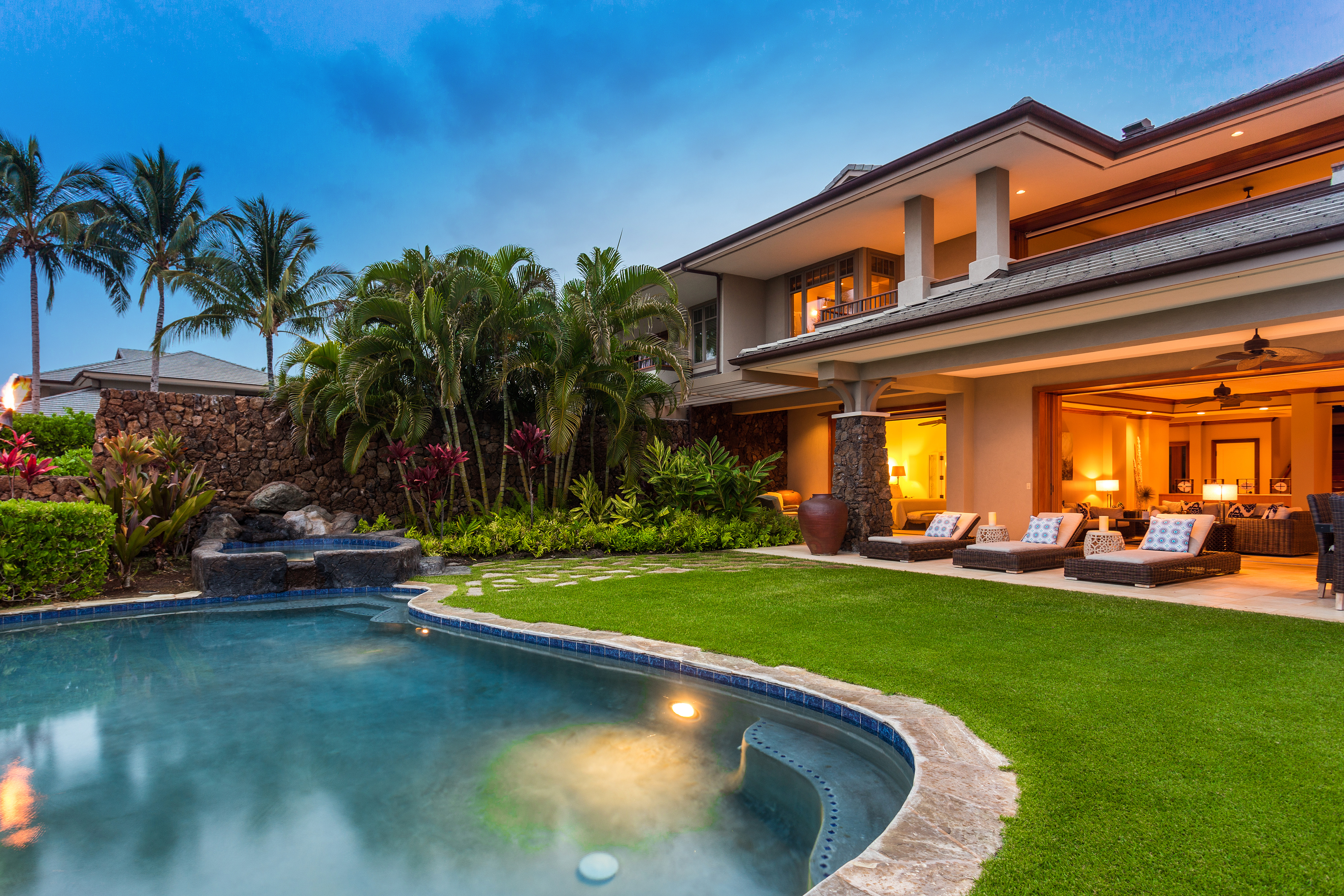 a view of a house with a swimming pool and sitting area