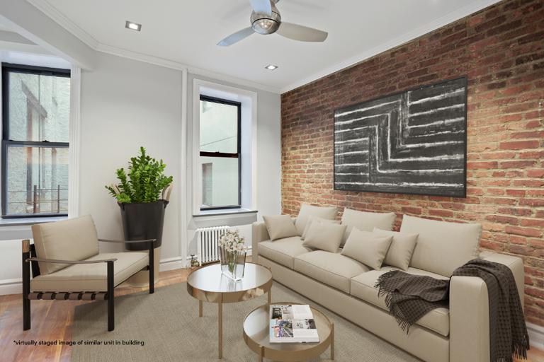 a living room with furniture and a potted plant