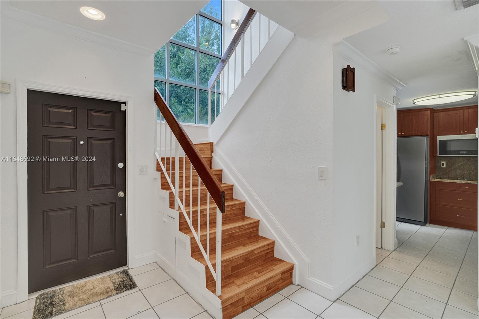 a view of entryway and hall with a door