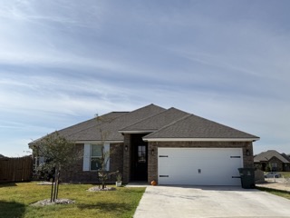 View of front of home featuring a garage and a fro