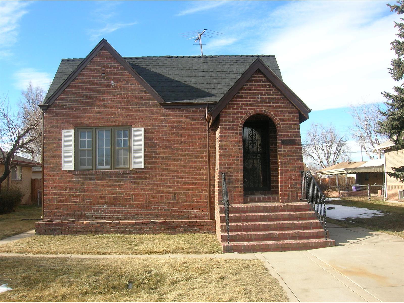 a view of a brick house with many windows