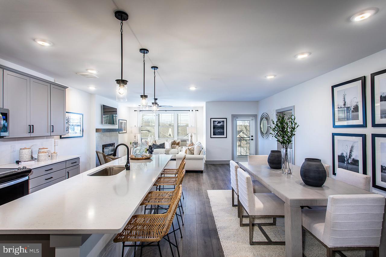 a large kitchen with sink a refrigerator and cabinets