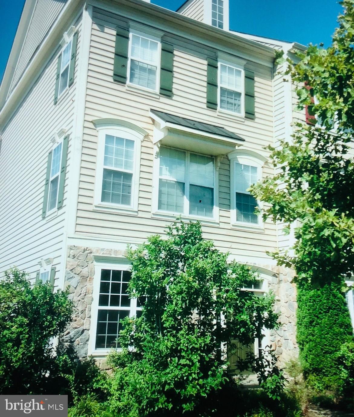 a view of a house with windows and plants