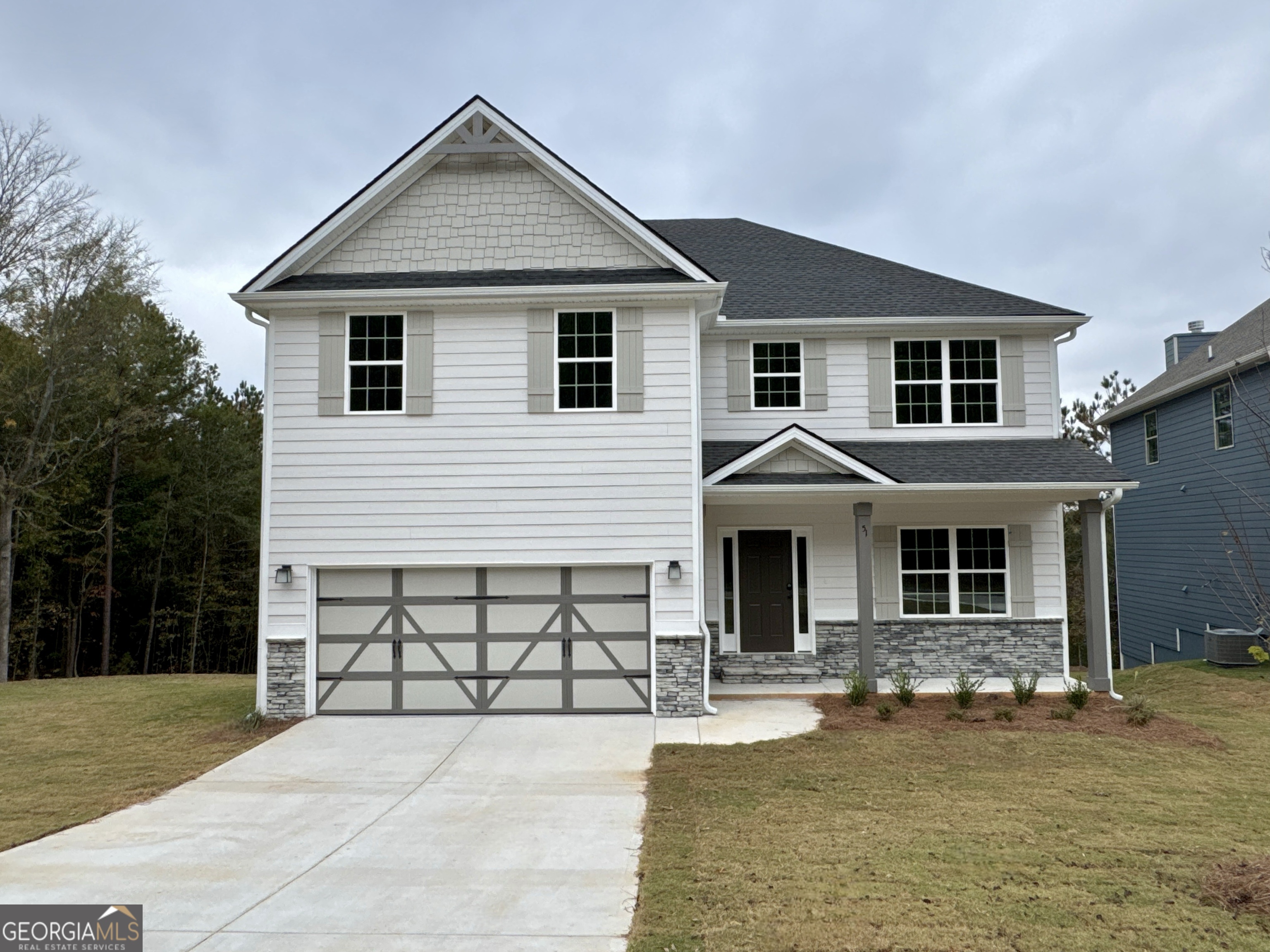 a front view of a house with yard and porch