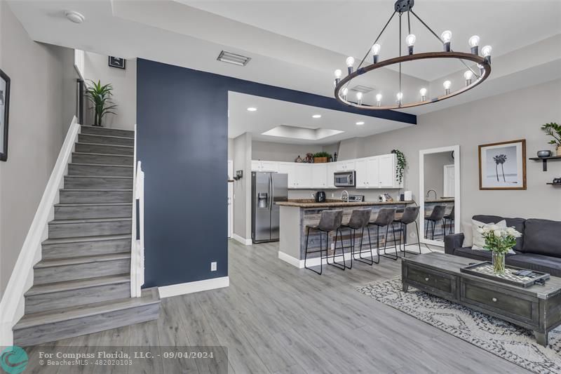 a view of a livingroom with furniture and a kitchen