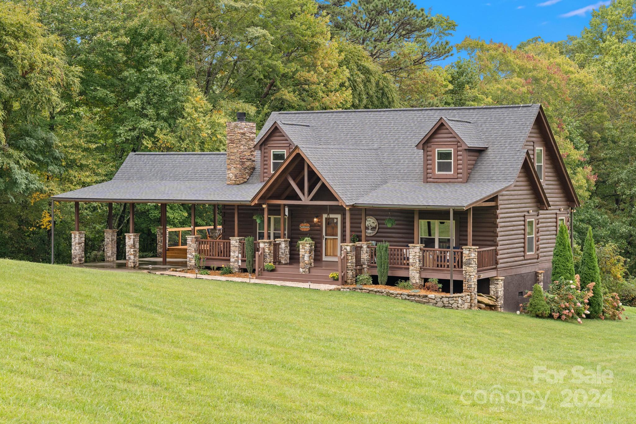 a view of a house with a yard and sitting area