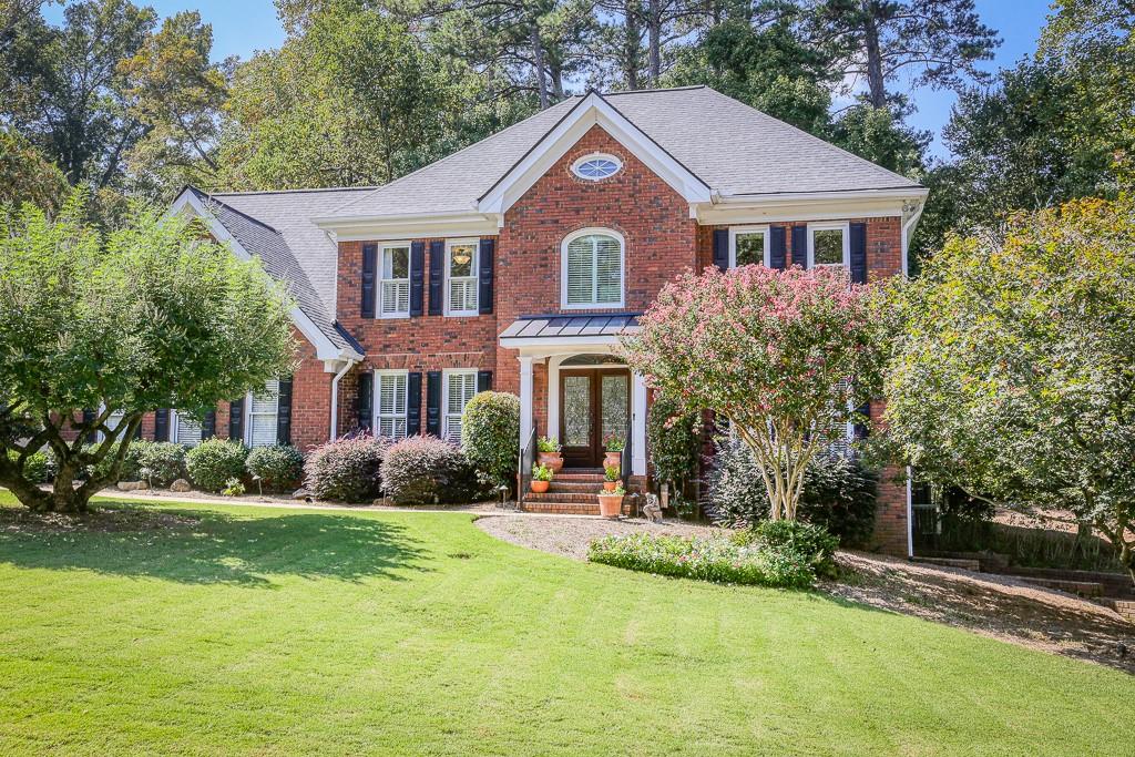 a front view of a house with a yard