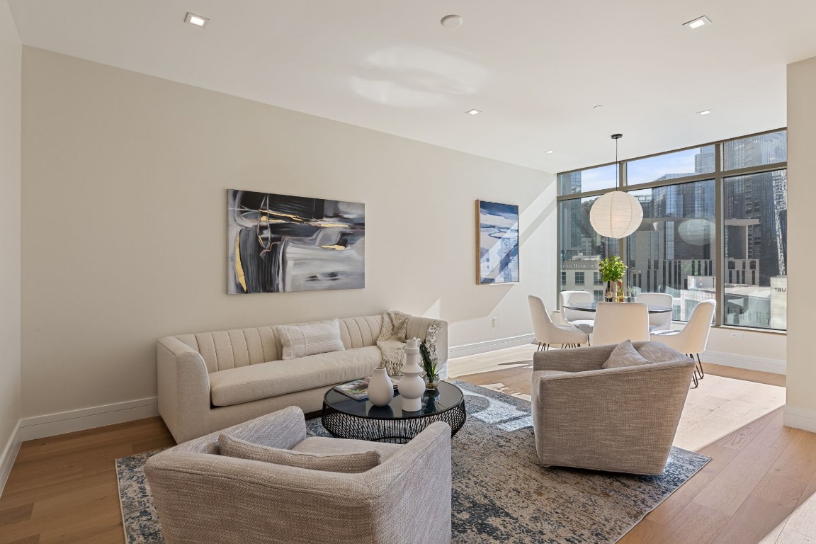 a living room with furniture and a glass door