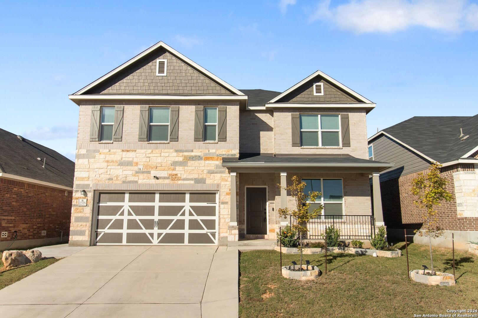 a front view of a house with a yard and garage