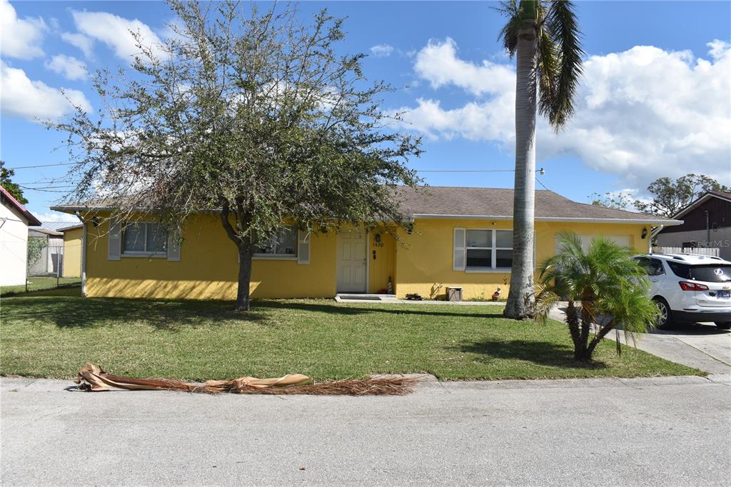 Front of house with Palm & oak trees