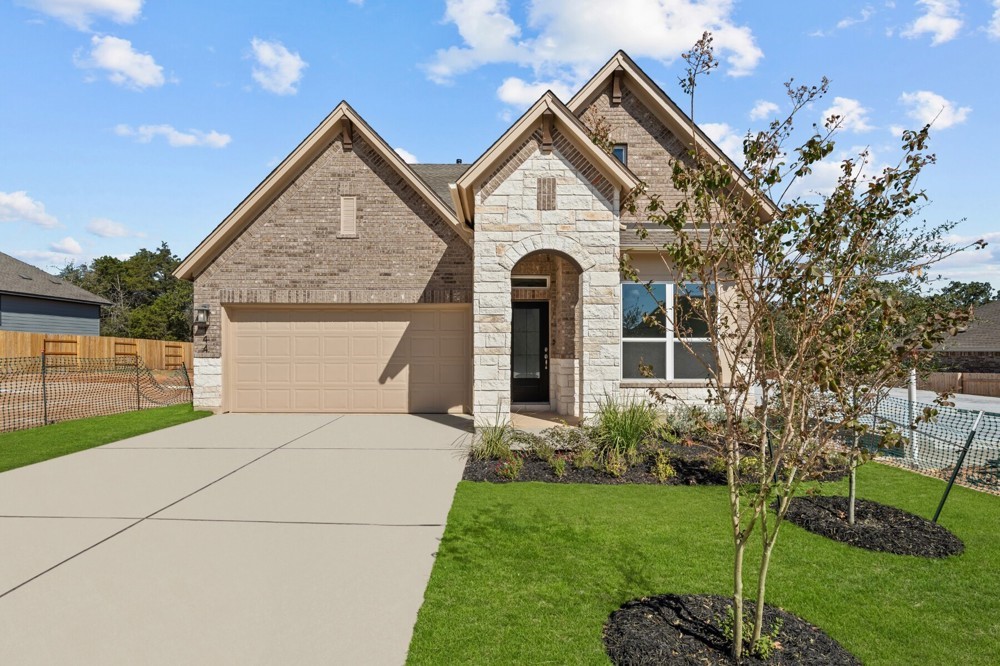 a front view of a house with a yard