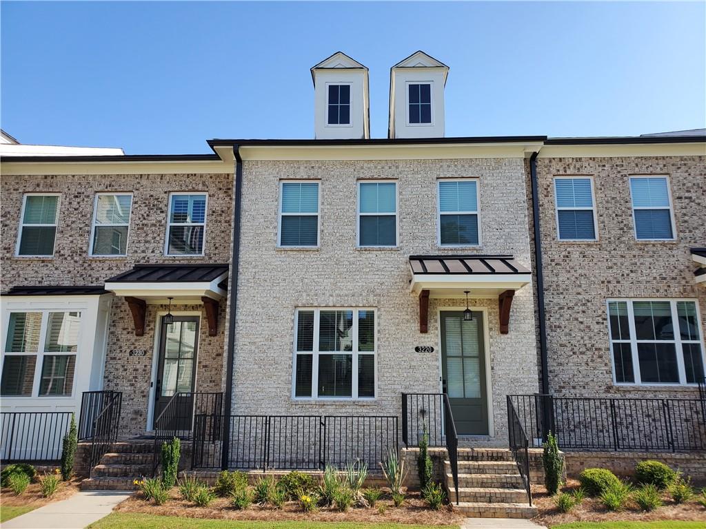 a front view of a house with that has lots of windows