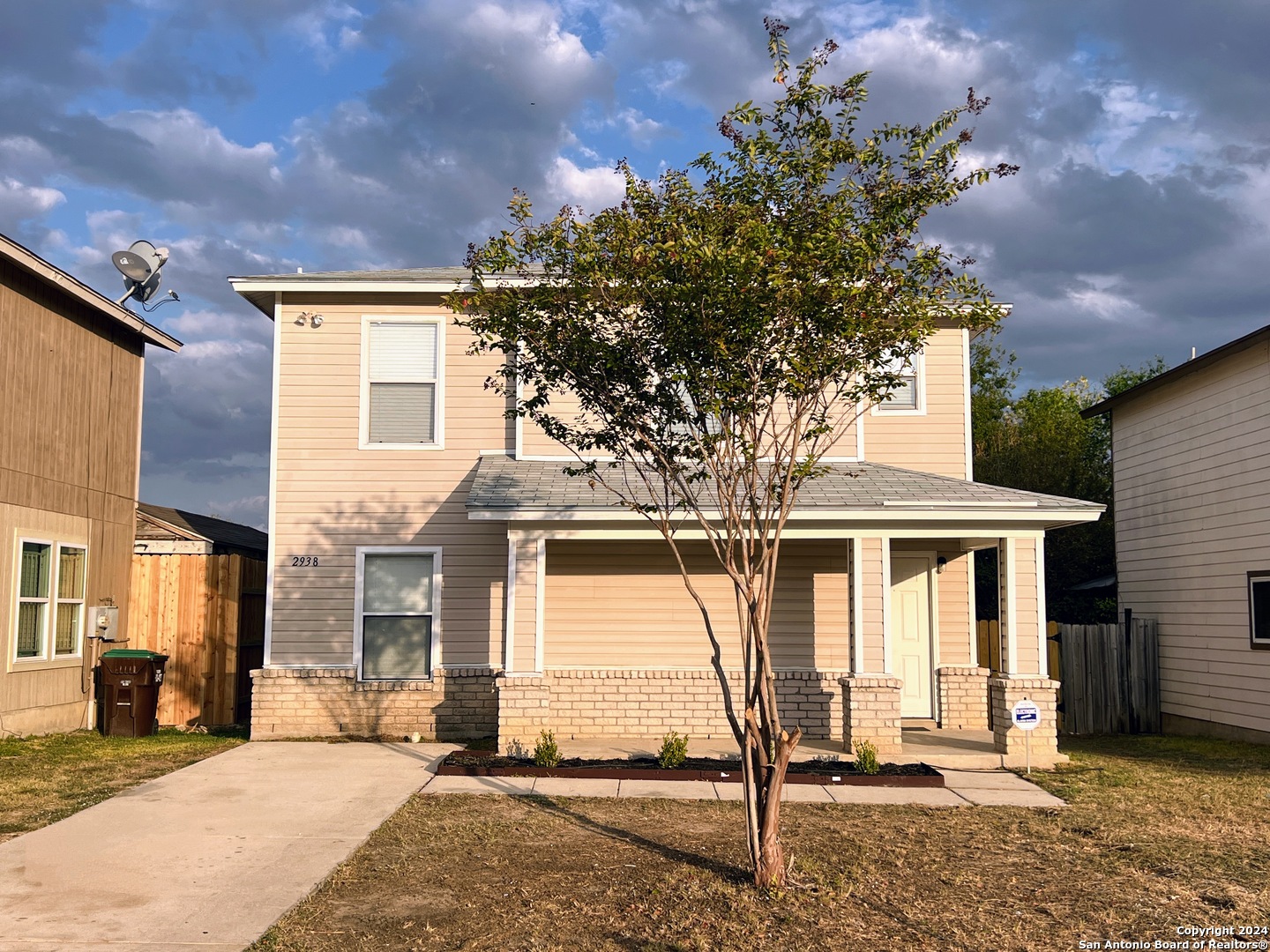 a view of a house with a tree in the background