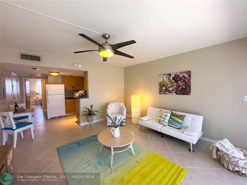 a living room with furniture and kitchen view