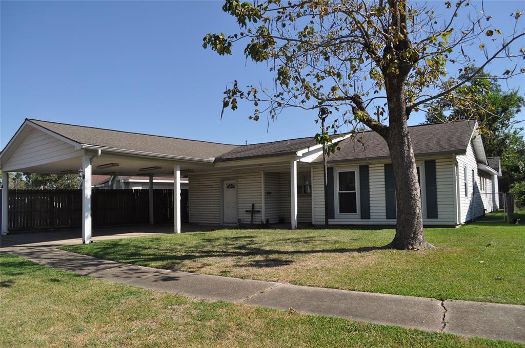 front view of a brick house with a yard