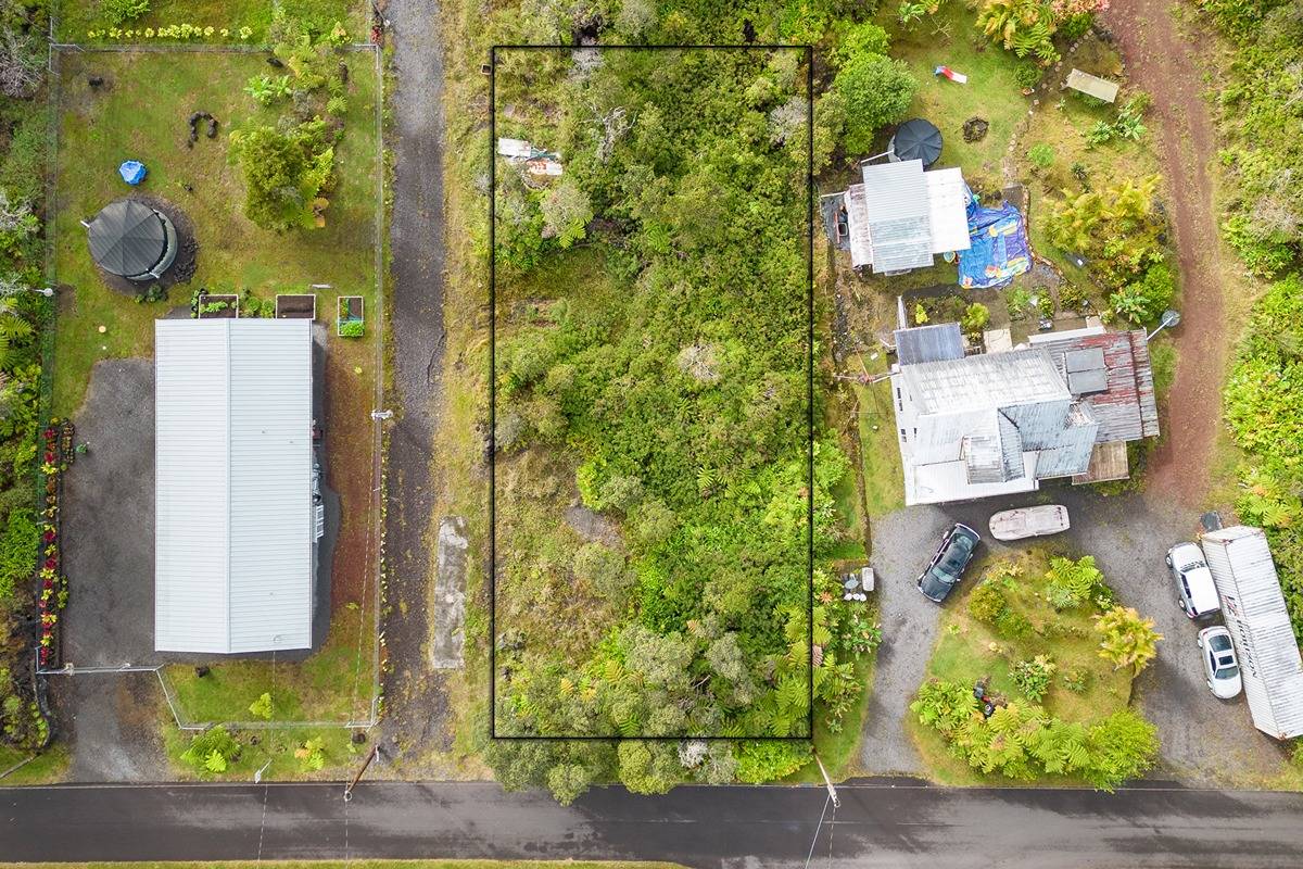 aerial view of a house with a yard and garden