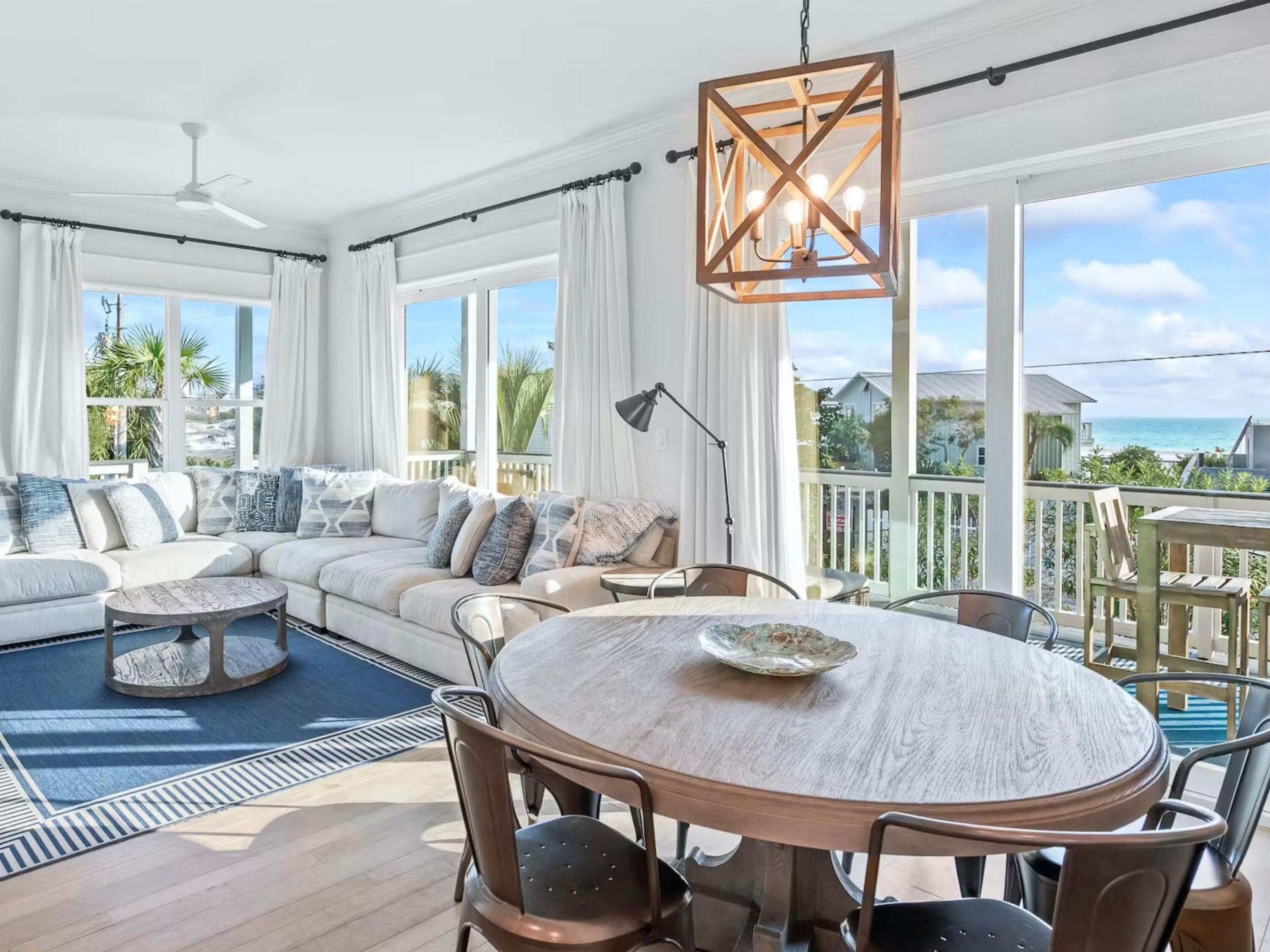 a living room with furniture a table and a large window