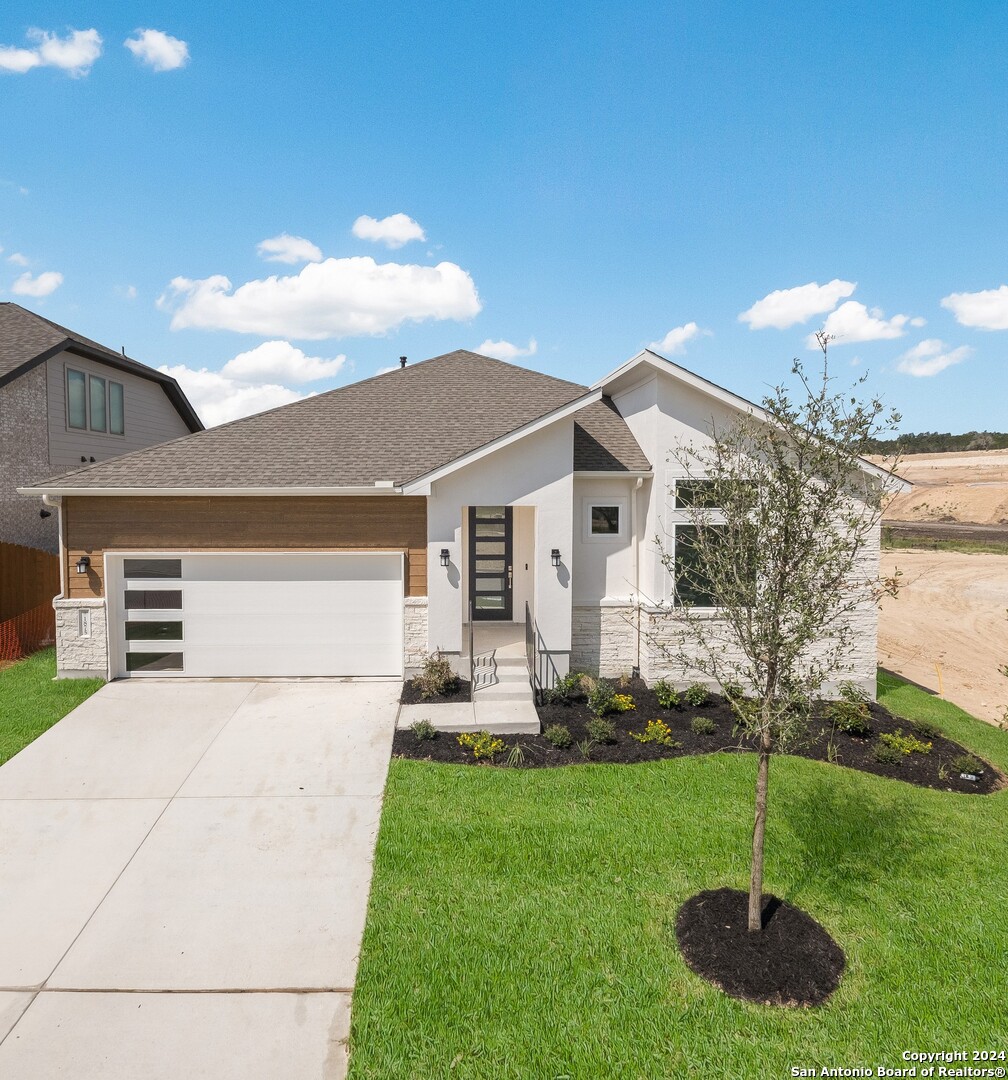 a front view of a house with a yard and garage