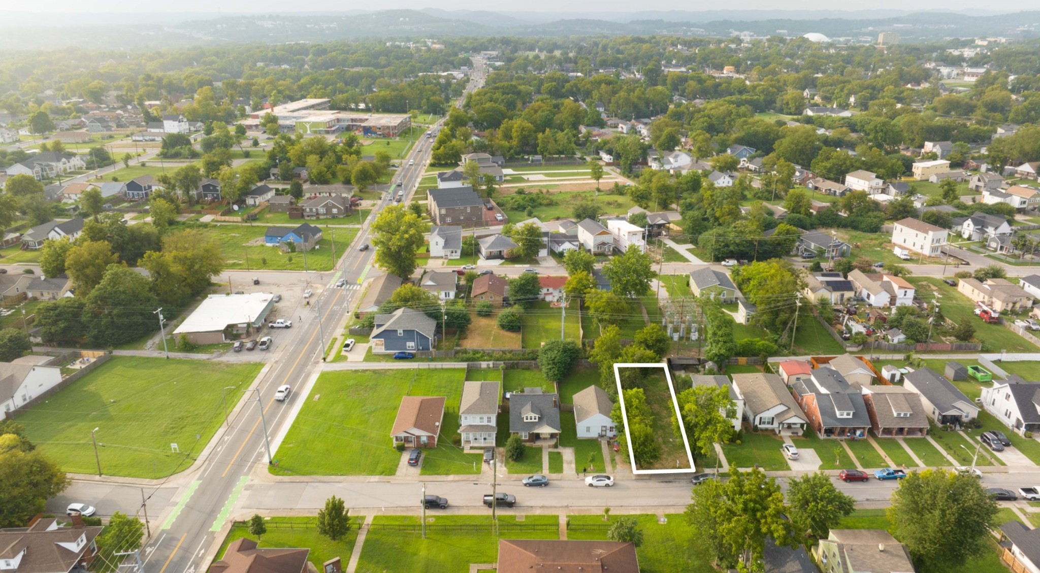 an aerial view of residential houses with outdoor space and swimming pool