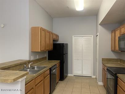 a kitchen with a sink and a refrigerator