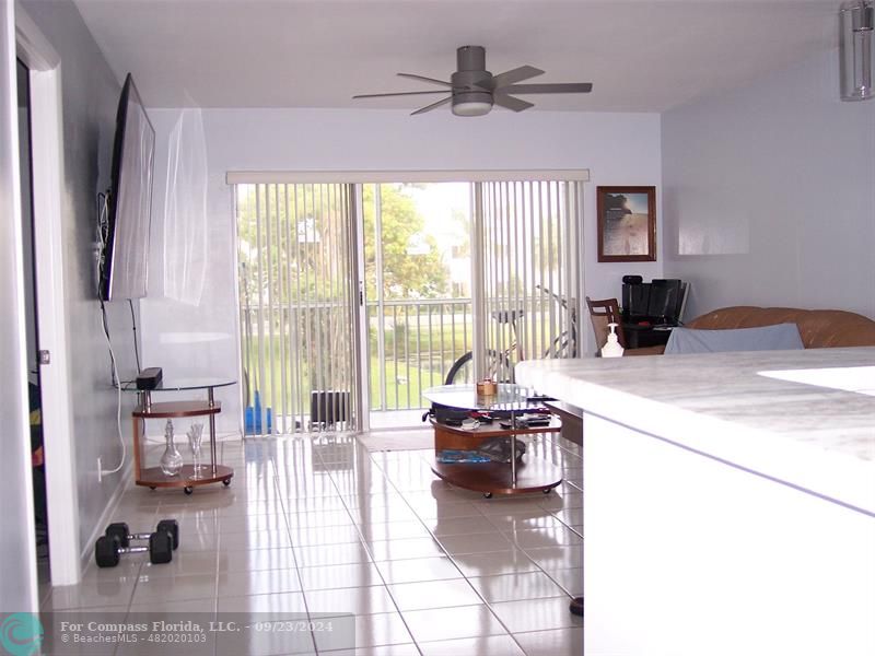 a living room with furniture and a floor to ceiling window