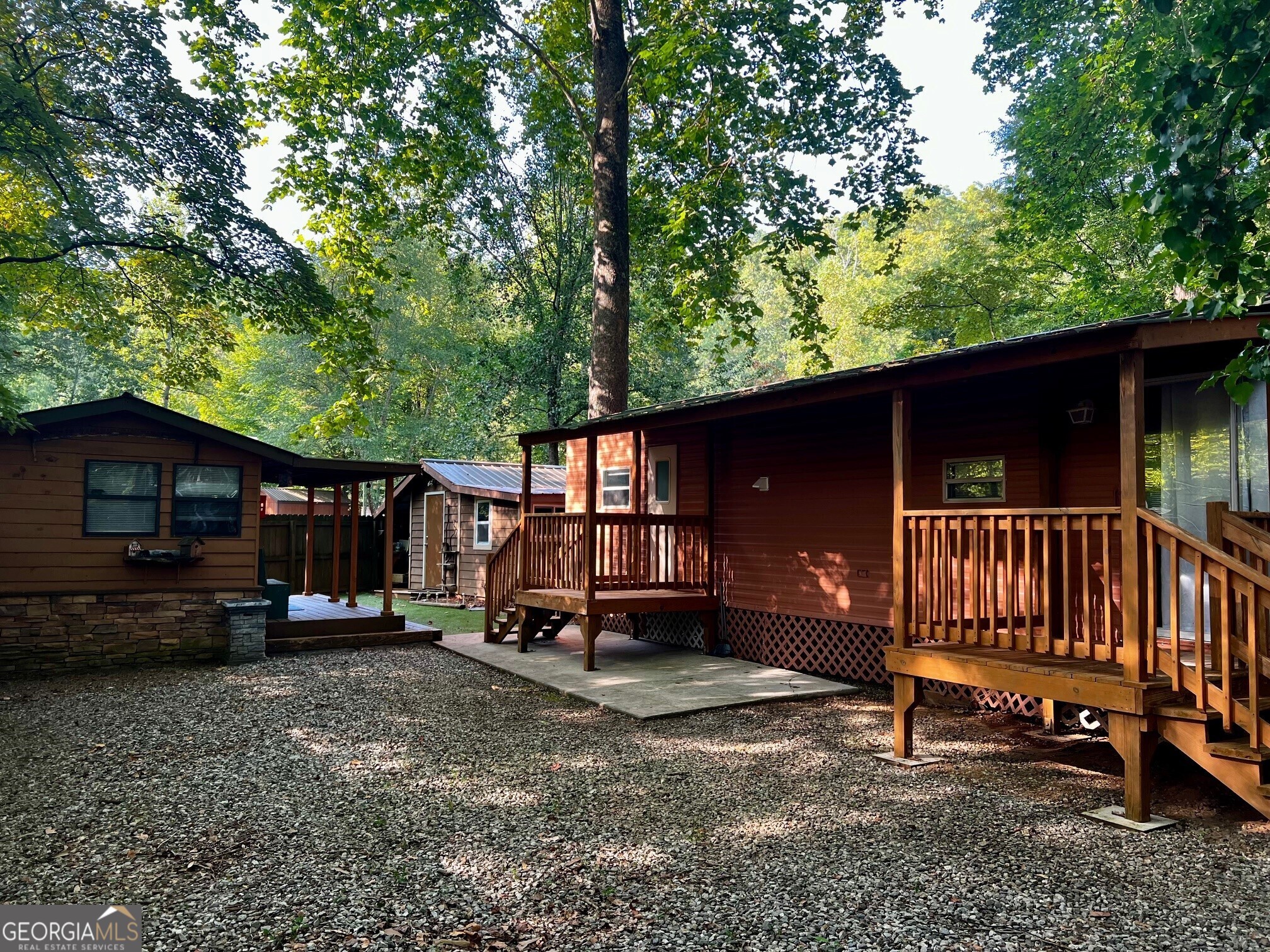 a view of a house with a yard and wooden deck