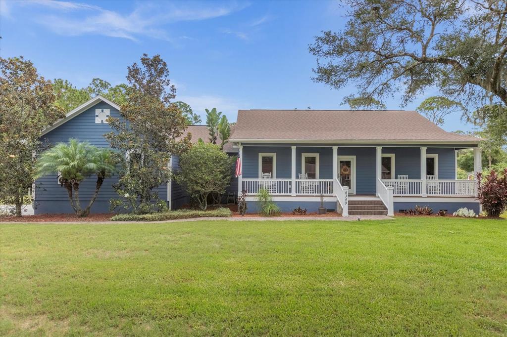 a house view with a sitting space and garden