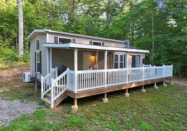 a view of a house with a yard and deck