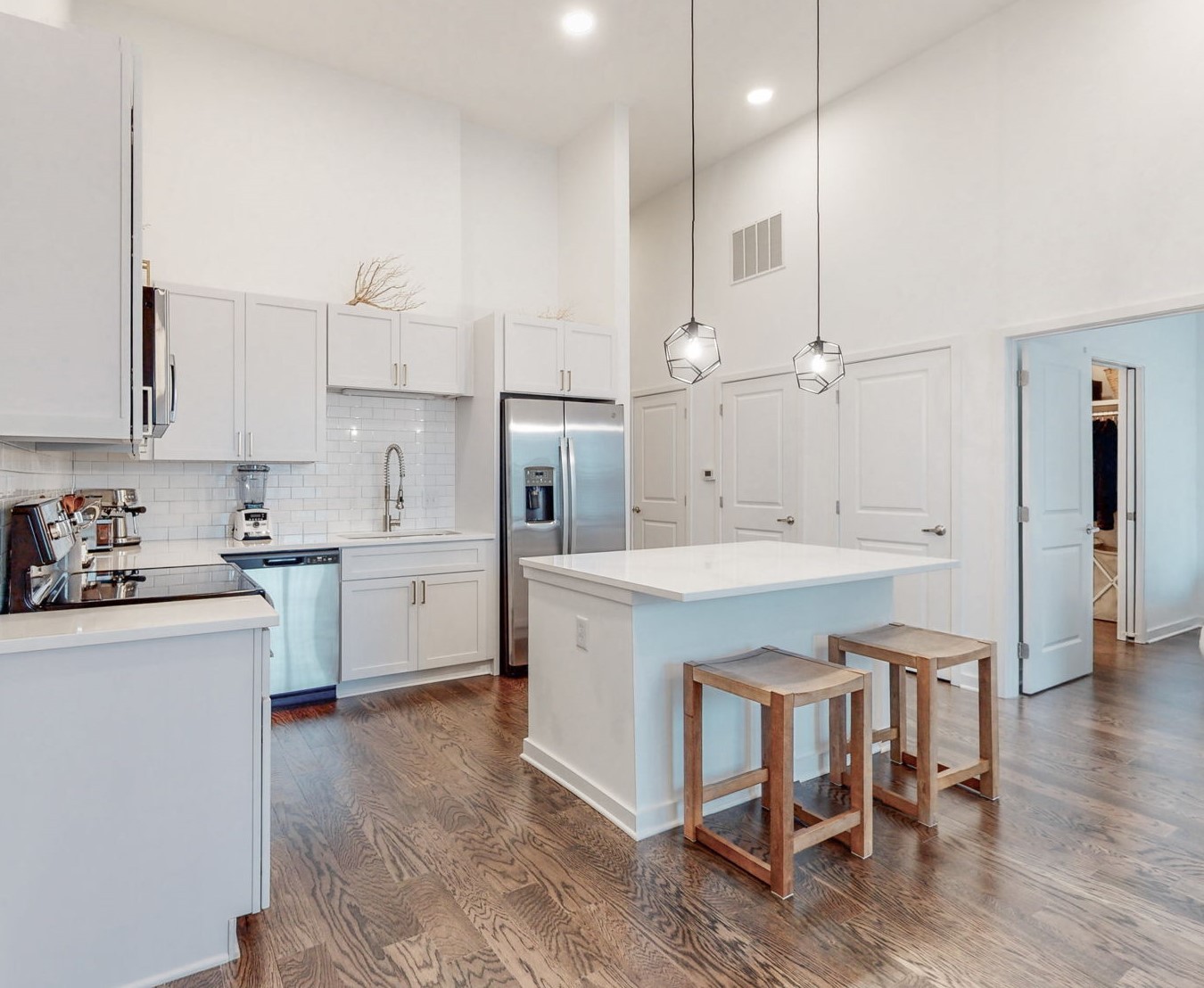 a kitchen with a sink cabinets and wooden floor