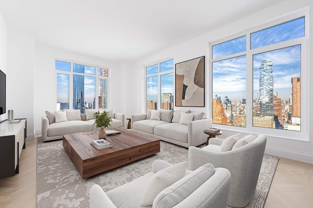 a living room with furniture large window and a table