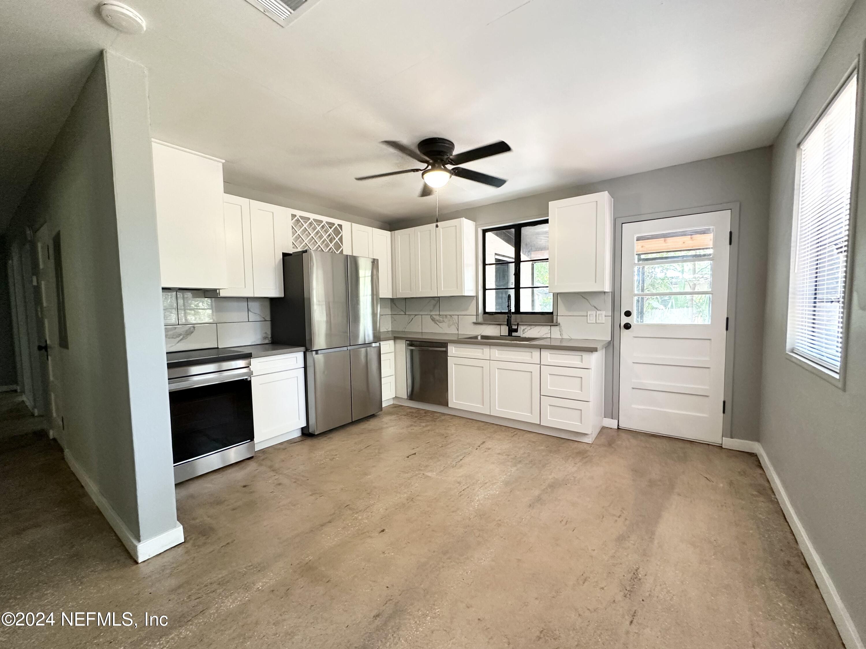 a kitchen with white cabinets and white appliances