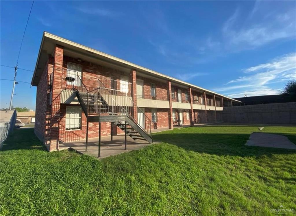 a view of an apartment with a backyard