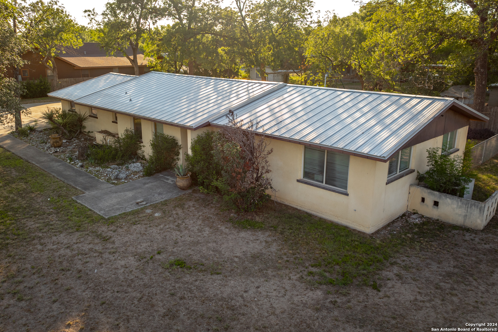 a view of a house with a yard and tree