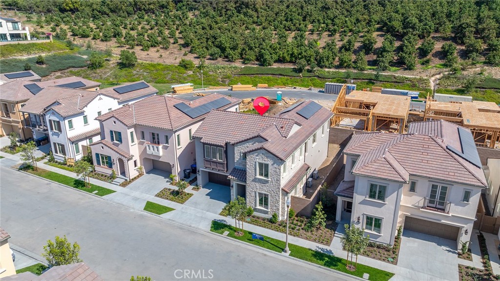 an aerial view of multiple houses with yard