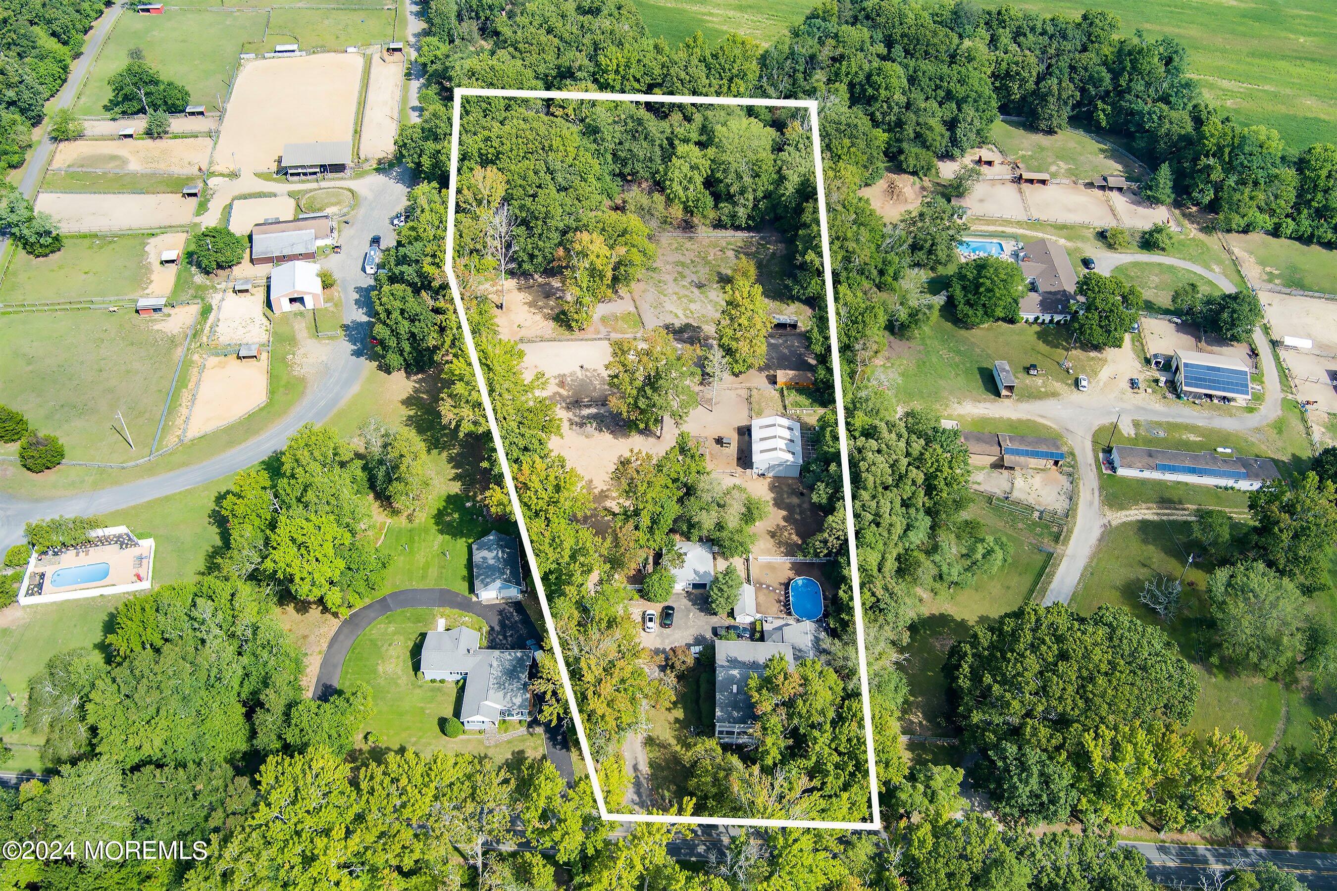 an aerial view of residential house with outdoor space and parking